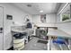 Well-equipped laundry room featuring stainless steel appliances, ample counter space, and built-in storage cabinets at 5350 Yellowstone St, Bow Mar, CO 80123