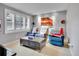 Comfortable living room with a dark wood coffee table, three blue recliner chairs and window with plantation shutters at 5350 Yellowstone St, Bow Mar, CO 80123
