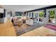 Bright living room with hardwood floors, fireplace, and backyard views at 5350 Yellowstone St, Bow Mar, CO 80123