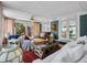 Bright and inviting living room featuring a large coffee table, comfortable seating, and views of the outdoors at 5350 Yellowstone St, Bow Mar, CO 80123