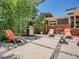 Outdoor seating area with a grill, lounge chairs, and a table, ideal for relaxing and entertaining at 5350 Yellowstone St, Bow Mar, CO 80123