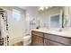 Well-lit bathroom with a shower-tub combination, vanity, and modern accents at 8742 E 47Th Ave, Denver, CO 80238