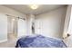 Comfortable bedroom showcasing a sliding barn door to the ensuite bathroom and stairs at 8742 E 47Th Ave, Denver, CO 80238
