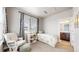 Charming bedroom with a comfortable chair, soft natural light, and serene decor at 8742 E 47Th Ave, Denver, CO 80238