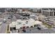 This aerial captures a bustling commercial area with various businesses and ample parking at 8742 E 47Th Ave, Denver, CO 80238