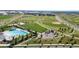 Aerial view of a community park with a pool, playground, baseball field, and green spaces at 8742 E 47Th Ave, Denver, CO 80238