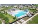 A resort-style community pool with waterslides and multiple lounge areas surrounded by green spaces at 8742 E 47Th Ave, Denver, CO 80238
