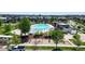 Aerial view of a community pool, playground, and recreational area surrounded by trees at 8742 E 47Th Ave, Denver, CO 80238