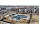 Aerial view of a community pool and gathering space with tables, chairs, and shade structures at 8742 E 47Th Ave, Denver, CO 80238