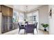 Cozy dining area with modern chandelier, views of the outside, and a stylish furniture set at 8742 E 47Th Ave, Denver, CO 80238