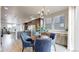 Stylish dining area with modern lighting, views of the kitchen, and a comfortable seating arrangement at 8742 E 47Th Ave, Denver, CO 80238