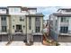 Townhome exterior featuring two stories, multiple balconies, and individual garages at 8742 E 47Th Ave, Denver, CO 80238