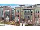 Modern townhomes showcase a mix of brick and siding and rooftop patios at 8742 E 47Th Ave, Denver, CO 80238