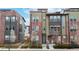 Beautiful townhome with brick accents, mature trees, and a welcoming front porch at 8742 E 47Th Ave, Denver, CO 80238