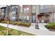 Charming front entrance featuring a modern door, brick accents, and a small patio at 8742 E 47Th Ave, Denver, CO 80238