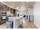 Spacious kitchen with modern appliances, a center island with seating, and open concept layout at 8742 E 47Th Ave, Denver, CO 80238