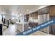 Modern kitchen with stainless steel appliances, a large island, and stylish pendant lighting fixture at 8742 E 47Th Ave, Denver, CO 80238