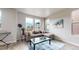 Bright living room features large windows, modern decor, and a comfortable sectional sofa at 8742 E 47Th Ave, Denver, CO 80238