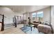 Bright living room with stylish furniture, a staircase, and large windows that offer great natural light at 8742 E 47Th Ave, Denver, CO 80238