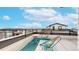 Relaxing roof deck boasts outdoor seating and scenic views under a bright blue sky with fluffy white clouds at 8742 E 47Th Ave, Denver, CO 80238