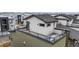 Aerial view showcases a charming roof deck with patio furniture overlooking the surrounding neighborhood at 8742 E 47Th Ave, Denver, CO 80238