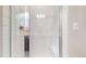 Walk-in shower with sleek glass enclosure and white subway tile at 8742 E 47Th Ave, Denver, CO 80238