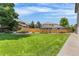 The spacious backyard showcases a well-manicured lawn, and tidy landscaping at 6643 Orion Ct, Arvada, CO 80007