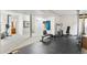 Finished basement area featuring carpet, rubber flooring, and workout equipment at 6643 Orion Ct, Arvada, CO 80007