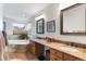 Bathroom featuring double sinks, granite counters, tile flooring, and a separate bathtub with a garden view at 6643 Orion Ct, Arvada, CO 80007