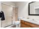 Cozy bathroom featuring tiled shower, classic toilet, and wood vanity with ample counter space at 6643 Orion Ct, Arvada, CO 80007