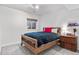 Charming bedroom with a wooden bed frame, cozy bedding, and a rustic nightstand at 6643 Orion Ct, Arvada, CO 80007