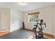 Bright bedroom featuring hardwood floors, a closet, and a modern exercise bike at 6643 Orion Ct, Arvada, CO 80007