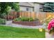 Circular brick flowerbed with decorative rock and lush green grass at 6643 Orion Ct, Arvada, CO 80007