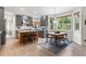 Open kitchen and dining area with modern grey cabinets, wood floors and lots of natural light at 6643 Orion Ct, Arvada, CO 80007
