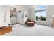 Bright living room with high ceilings, a comfortable chair, and a large window with a view at 6643 Orion Ct, Arvada, CO 80007