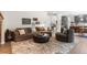 Cozy living room with plush seating, neutral decor, and hardwood floors adjacent to the kitchen at 6643 Orion Ct, Arvada, CO 80007