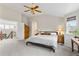 Spacious main bedroom with vaulted ceiling, ceiling fan, and large windows for ample natural light at 6643 Orion Ct, Arvada, CO 80007