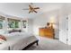 Inviting main bedroom with ample natural light, wood furniture, vaulted ceiling, and a ceiling fan at 6643 Orion Ct, Arvada, CO 80007