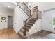 Traditional staircase with wood banister and carpeted steps, showcasing the home's welcoming entrance at 6643 Orion Ct, Arvada, CO 80007