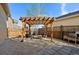 Outdoor patio with stone flooring, a wooden pergola, comfortable seating and wooden fence at 11896 Meade Ct, Westminster, CO 80031