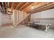 Unfinished basement with exposed beams offers plenty of space and includes a ping pong table at 11896 Meade Ct, Westminster, CO 80031