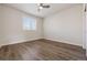This bedroom features wood floors, large window with blinds, and neutral paint for a relaxing ambiance at 11896 Meade Ct, Westminster, CO 80031