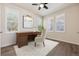Inviting bedroom with a decorative rug, hardwood floors, three windows, and a charming desk at 11896 Meade Ct, Westminster, CO 80031