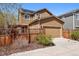 Charming two-story home features a well-maintained yard, fenced garden, and attached two car garage at 11896 Meade Ct, Westminster, CO 80031