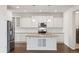 Bright kitchen features granite counters, stainless steel appliances, white cabinetry, and lots of natural light at 11896 Meade Ct, Westminster, CO 80031
