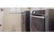 Convenient laundry area with a side-by-side washer and dryer setup, and natural lighting from the window at 11896 Meade Ct, Westminster, CO 80031