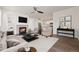 Cozy living room featuring a fireplace, hardwood floors, ceiling fan, and neutral tones for a warm ambiance at 11896 Meade Ct, Westminster, CO 80031
