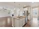 Spacious living room and kitchen featuring hardwood floors, stainless steel appliances, fireplace, and an open layout at 11896 Meade Ct, Westminster, CO 80031