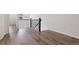 Open loft space featuring wood flooring, a dark wood banister and bright, natural light at 11896 Meade Ct, Westminster, CO 80031