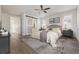 Spacious main bedroom features a barn door to the bathroom, a ceiling fan, and light, neutral decor at 11896 Meade Ct, Westminster, CO 80031